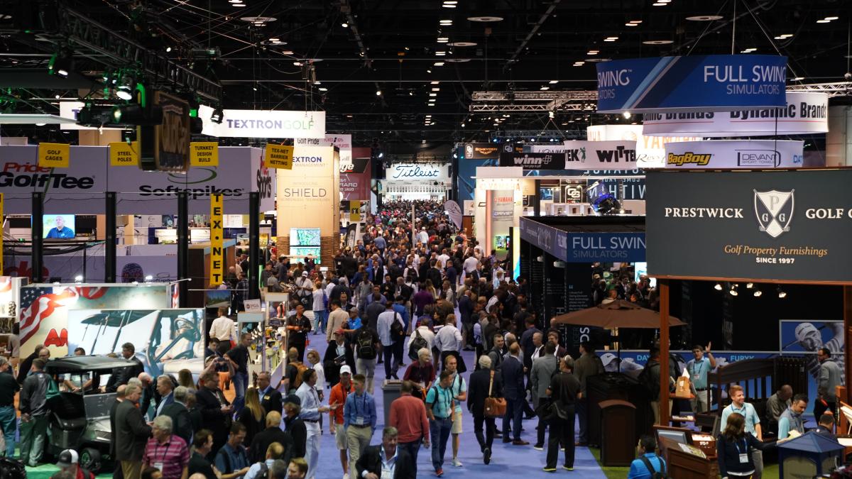 A wide photo of the floor of the PGA merchandise show full of vendor booths and people.